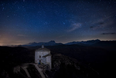 Scenic view of mountain against sky at night