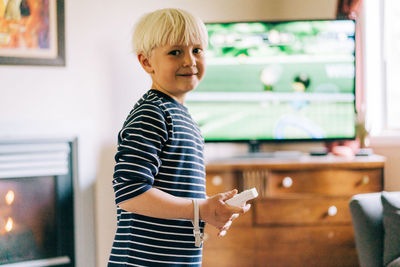 Young boy playing video games on tv