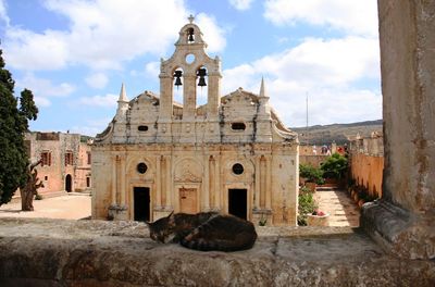 Church in front of cat sleeping on wall