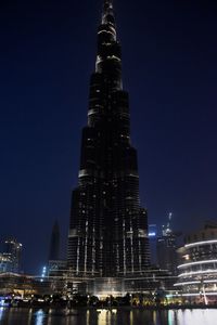 Illuminated buildings against sky at night