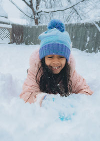 Portrait of smiling young woman in snow