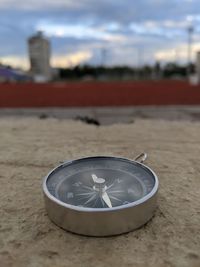 Close-up of clock on sand