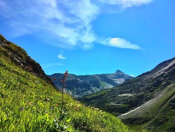 Scenic view of mountains against blue sky