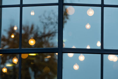 Close-up of illuminated street light against sky at night