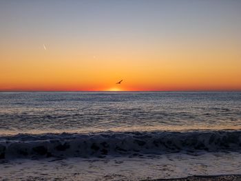 Scenic view of sea against sky during sunset
