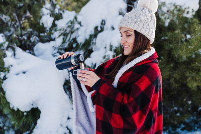 Woman pouring coffee during winter