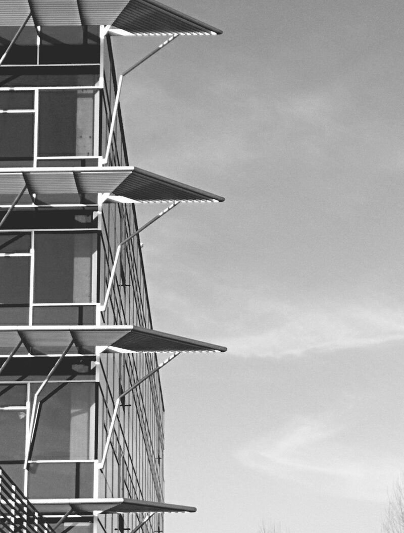 low angle view, architecture, built structure, building exterior, sky, building, cloud - sky, day, outdoors, no people, cloud, modern, high section, tall - high, directly below, tower, city, cloudy, part of, metal