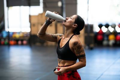 Midsection of woman exercising in gym