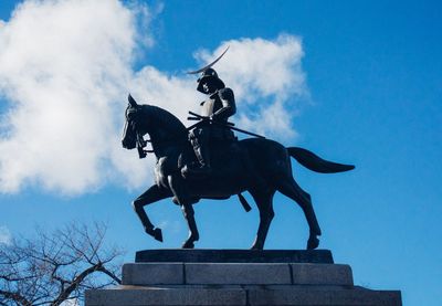 Low angle view of statue against sky