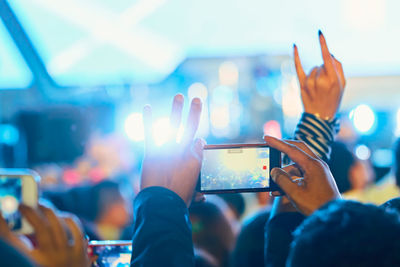 People photographing illuminated smart phone