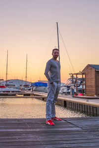 Portrait of man standing on boat against clear sky