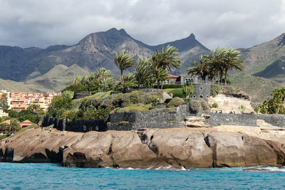 View on costa adeje on canary island tenerife with mountain range in the background