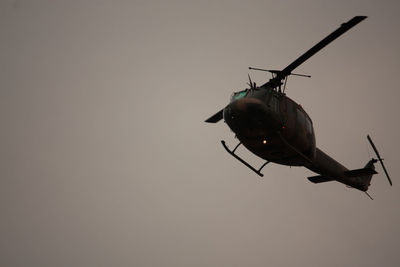 Low angle view of helicopter flying in sky