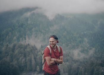 Portrait of young man standing on mountain