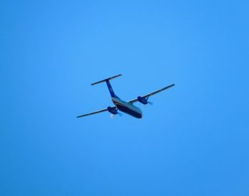 Low angle view of airplane flying in sky