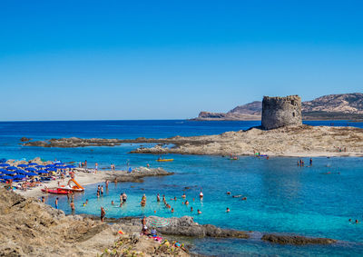 Scenic view of sea against clear blue sky