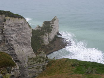 Scenic view of sea by cliff
