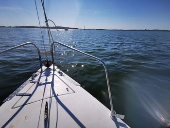 Sailboat sailing on sea against sky