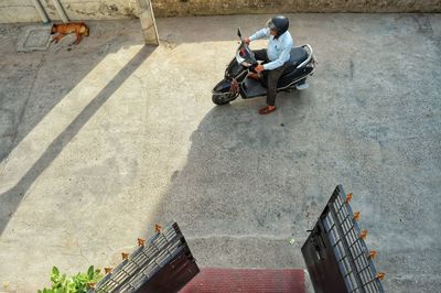 High angle view of man riding motor scooter