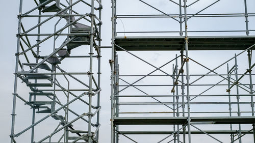 Steel scaffolding on cloudy sky