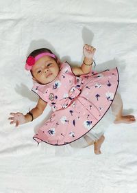 Full length of cute girl with pink umbrella