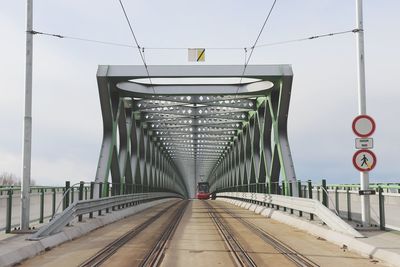 Footbridge against sky in city