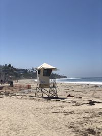 Lifeguard hut on beach against clear sky