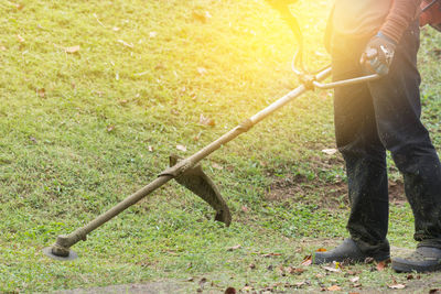 Low section of man standing on grass