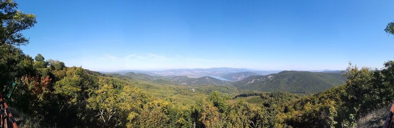 Scenic view of mountains against blue sky