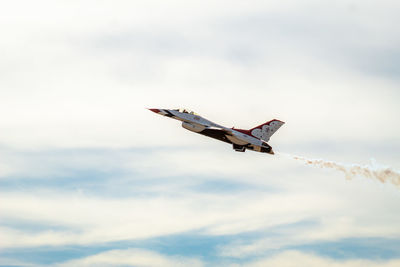 Low angle view of airplane flying against sky