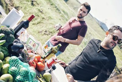 Young man and fruits on cutting board