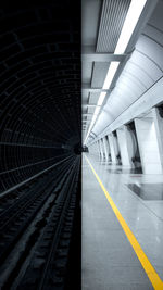 Empty railroad tracks in tunnel