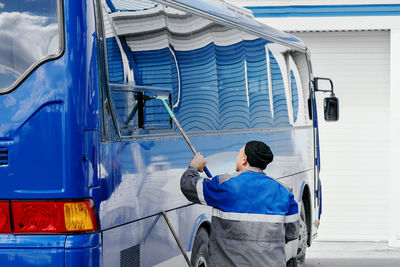 Rear view of man standing in train