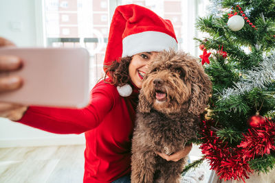 Young woman with dog in front of hat