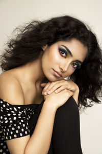 Portrait of young woman against white background