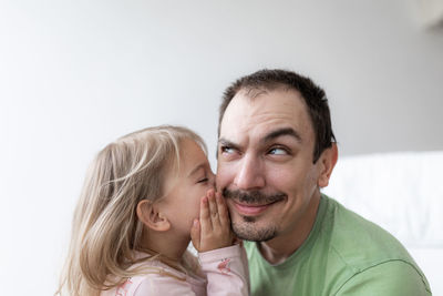 Portrait of young caucasian man with a little girl. father and daughter together 