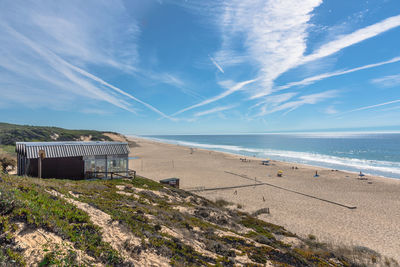 Scenic view of beach against blue sky