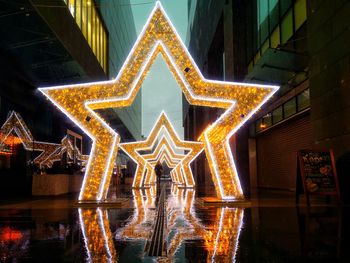 Reflection of illuminated building on water at night