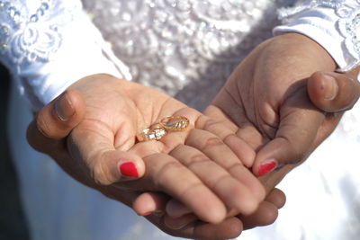 Midsection of couple holding hands