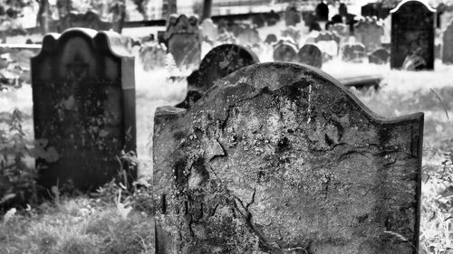 Close-up of old cross in cemetery