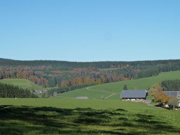 Scenic view of green landscape against clear sky