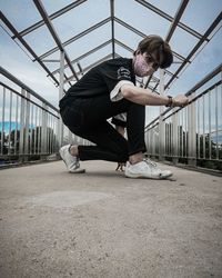Full length of young man skateboarding on railing