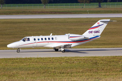 Side view of airplane on airport runway