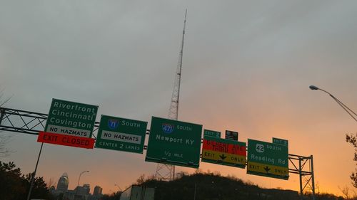 Low angle view of road sign against sky