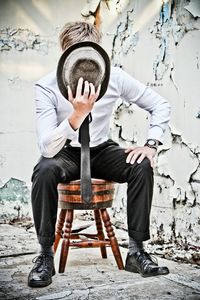 Young man sitting on chair