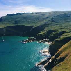 Scenic view of sea and mountains against sky