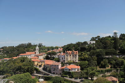 Buildings in town against sky