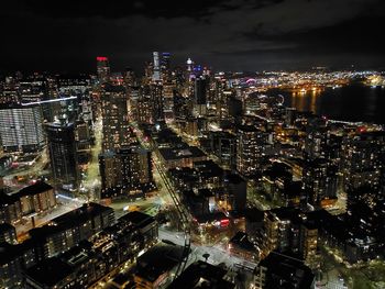High angle view of illuminated buildings in city at night