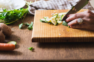 Cropped image of person chopping zucchini