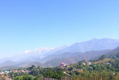 Scenic view of mountains against clear blue sky